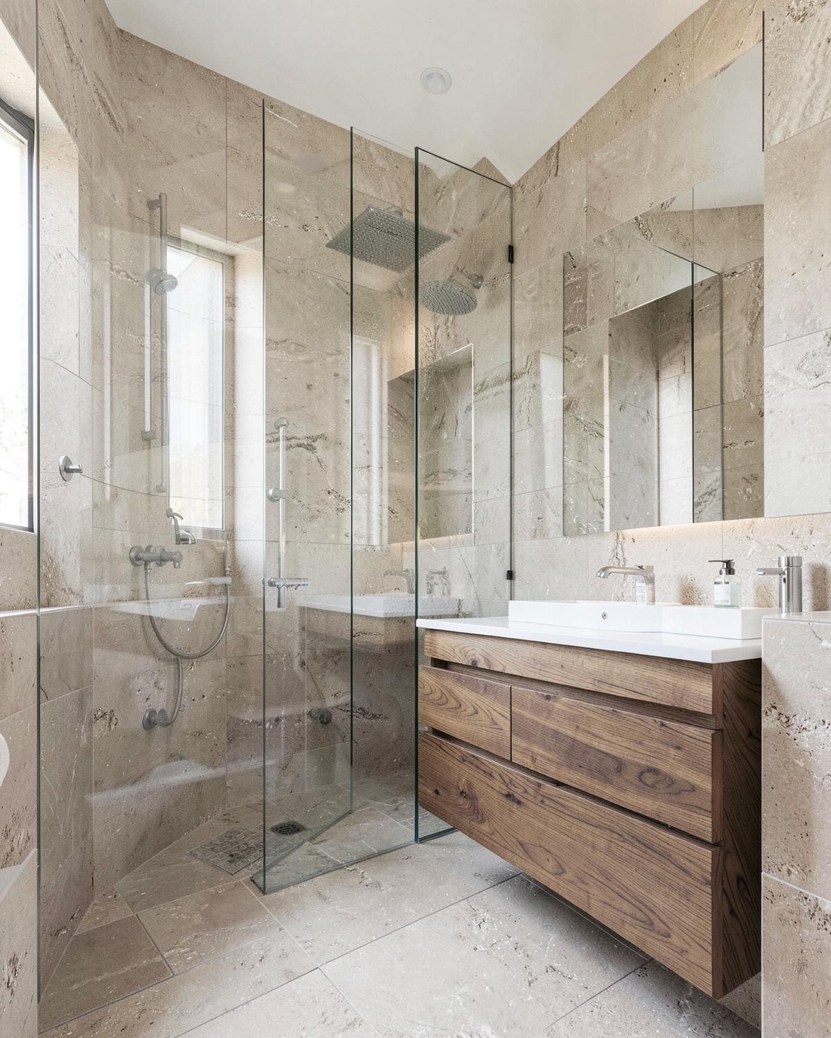 Modern bathroom with stone tile and floating wood vanity